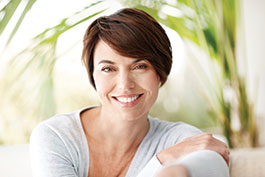 Photo of a woman smiling. Link to Life Stage Gift Planner Under Age 60 Situations.
